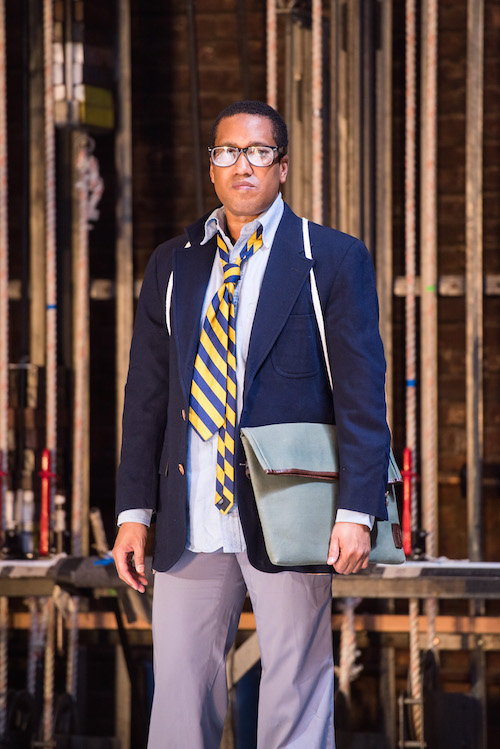 Trajal Harrell in glasses and preppy suit with a loosened tie
